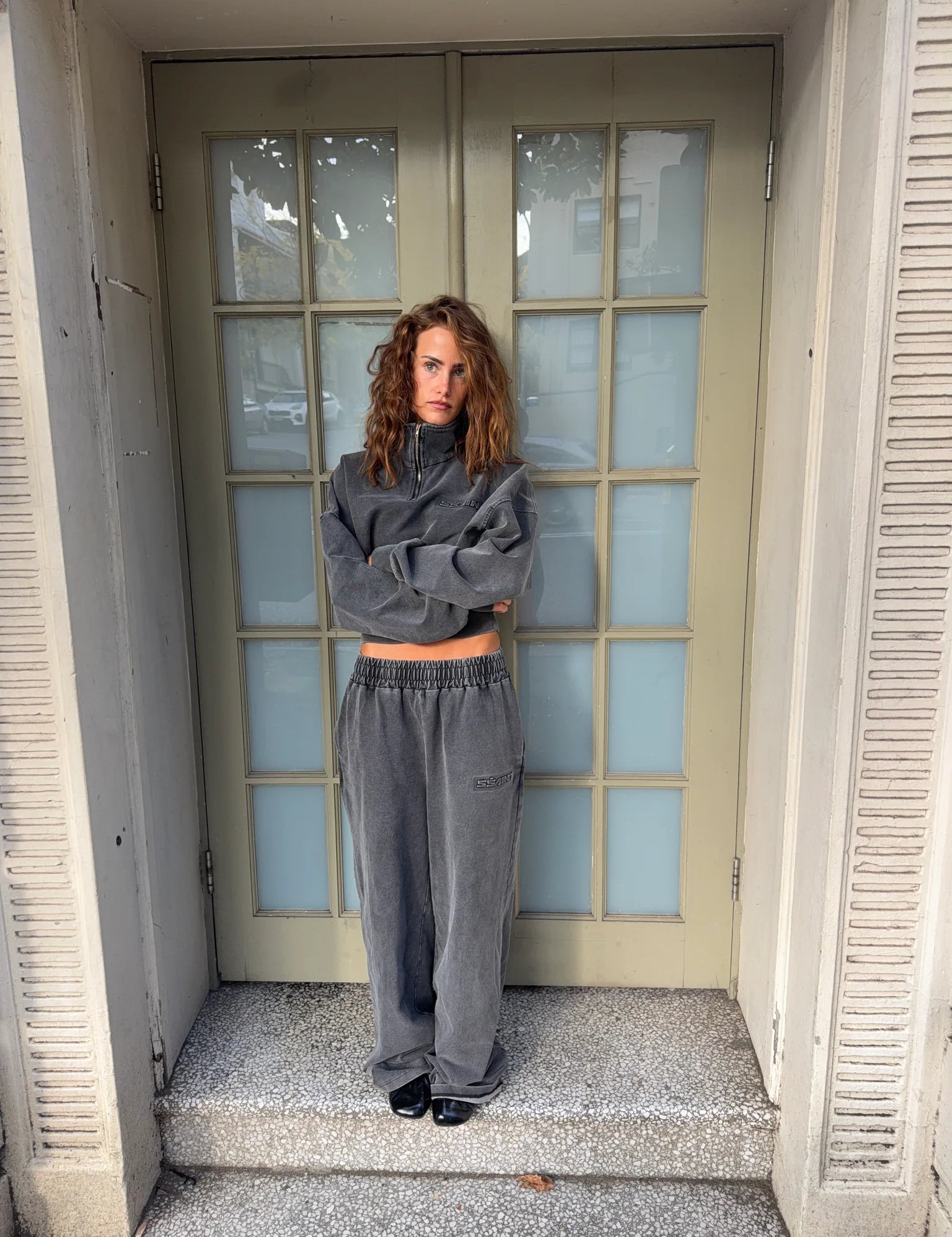 Woman modeling a charcoal acid-wash cropped sweatshirt and wide-leg pants set