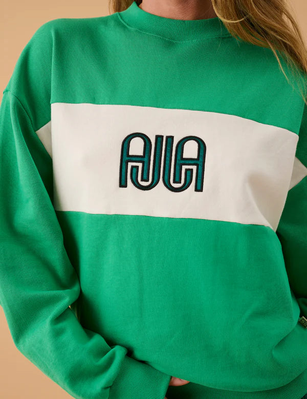 Green and white sweatshirt with 'AJIA' logo on a beige background
