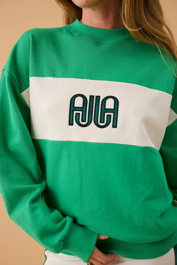 Green and white sweatshirt with 'AJIA' logo on a beige background