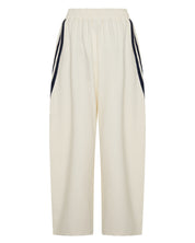 BACK ŚSAINT Barrel Trackpant in butter with navy double side stripe detail