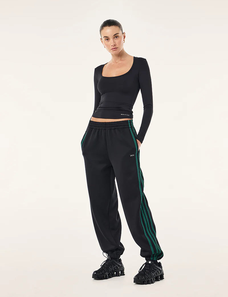 PE Nation Clarity Trackpant in black, styled with black long sleeve top
