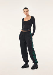 PE Nation Clarity Trackpant in black, styled with black long sleeve top
