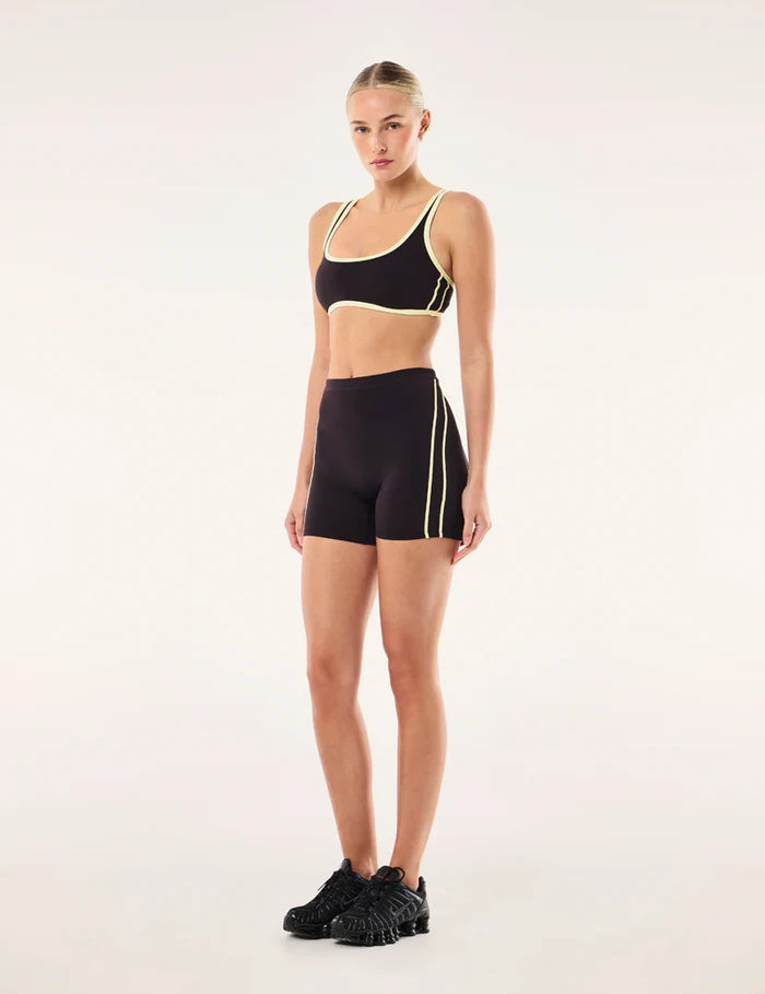 model shot wearing PE Nation Cypher Bike Short in Black Bean & Soft Yellow — high-rise squat-proof activewear short, Wild West Sisters