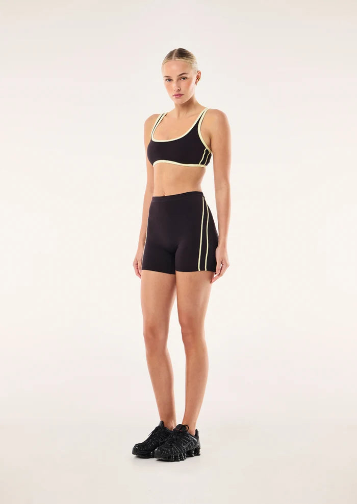model shot wearing PE Nation Cypher Bike Short in Black Bean & Soft Yellow — high-rise squat-proof activewear short, Wild West Sisters