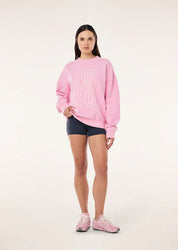 Model wearing PE Nation Elysian Sweat layered for off-duty styling