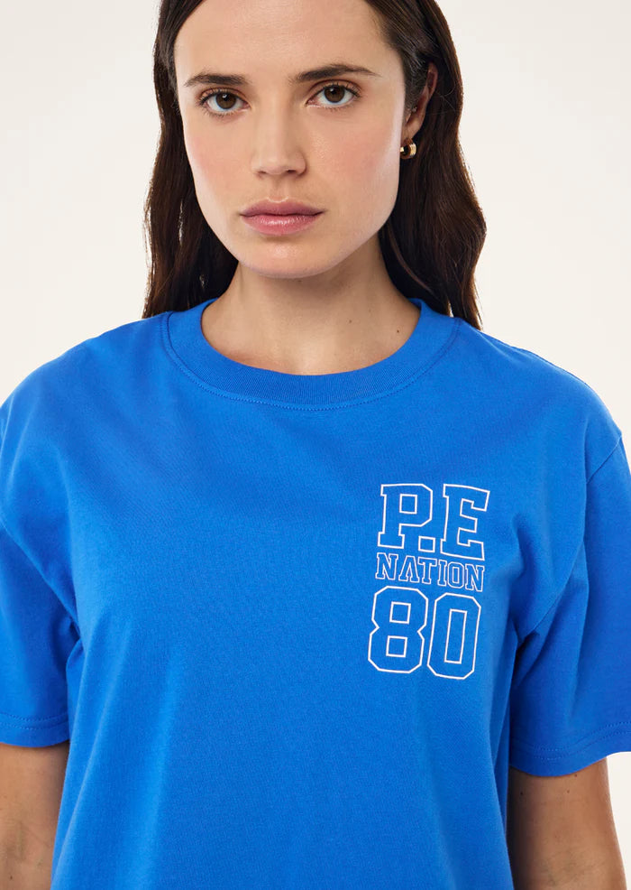 Close-up of P.E Nation graphic chest print on Elysian Tee