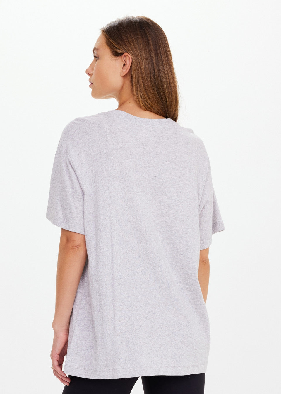 Woman wearing a light gray t-shirt on a white background