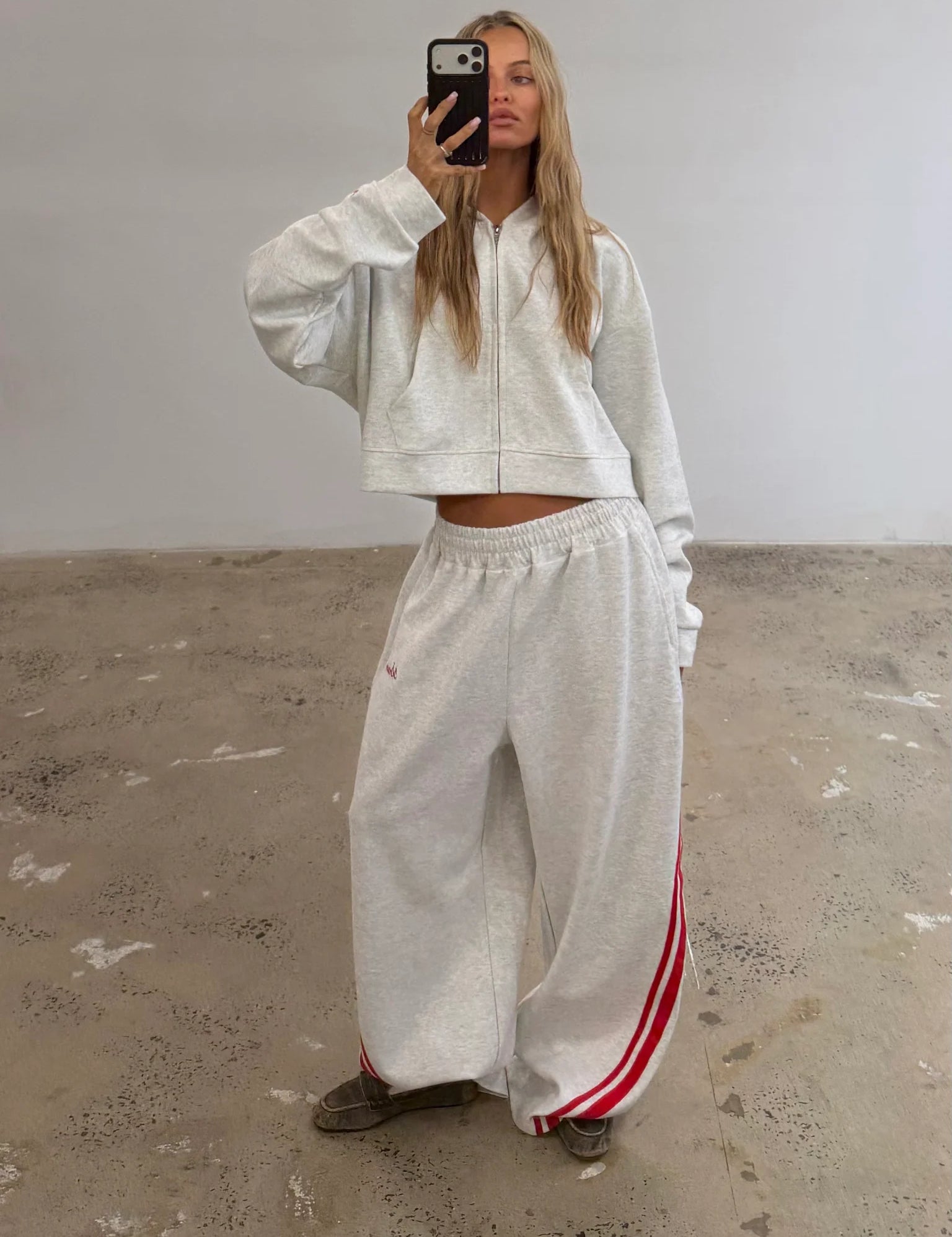 Grey SSAINT lounge set featuring a cropped hoodie and relaxed wide-leg track pants