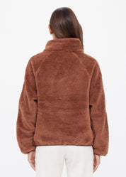 The Upside Harlow Fleece Pullover in Walnut brown — back view on model, relaxed sherpa pullover with quarter zip