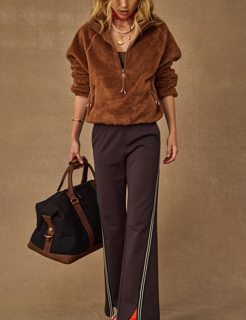 Woman wearing The Upside Harlow Fleece Pullover in Walnut brown — relaxed sherpa layer styled for everyday wear
