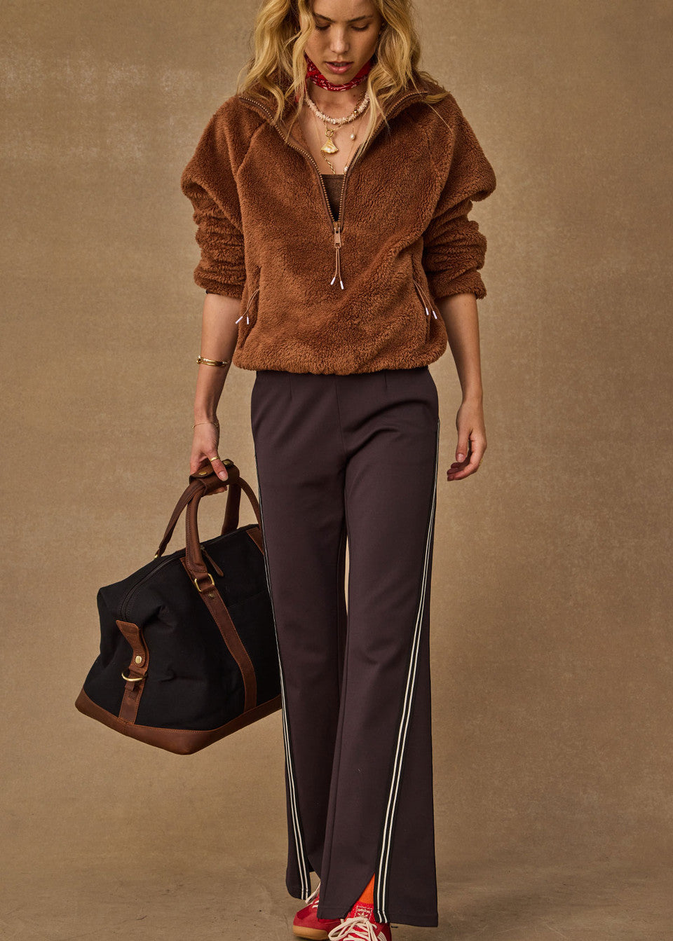 Woman wearing The Upside Harlow Fleece Pullover in Walnut brown — relaxed sherpa layer styled for everyday wear
