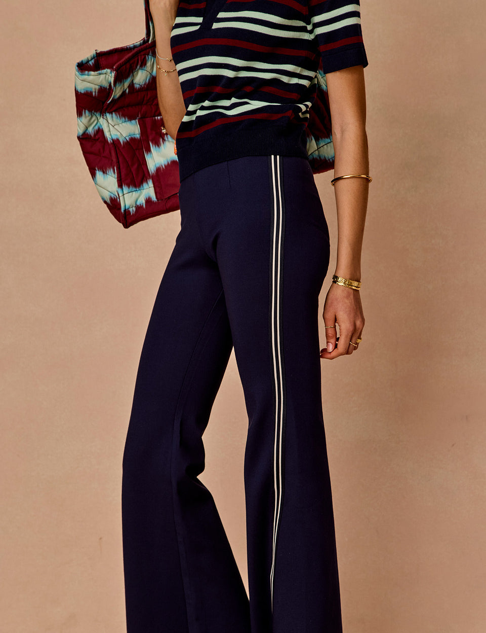 The Upside Joyela Panelled Flare Pant in navy with striped side seam tape