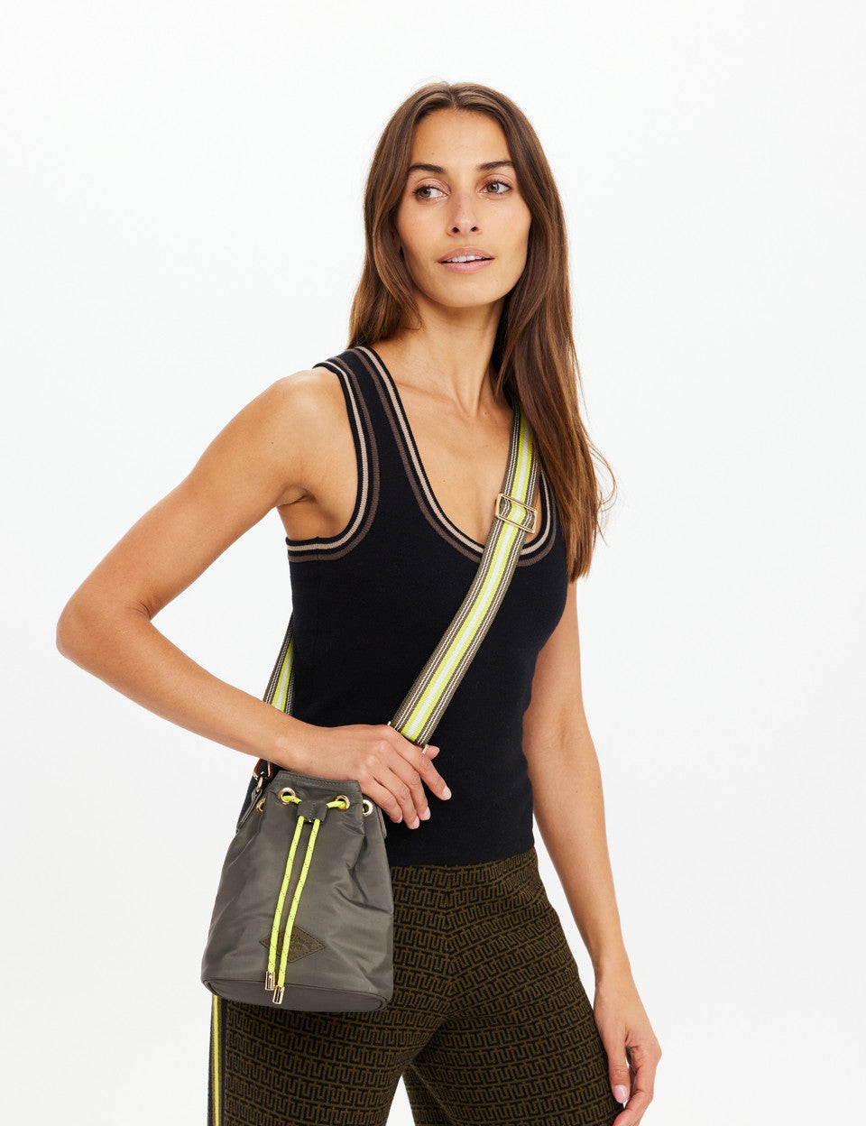 Model carrying The Upside Oxford Bucket Bag olive sport luxe bucket bag