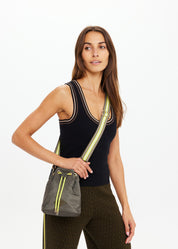 Model carrying The Upside Oxford Bucket Bag olive sport luxe bucket bag