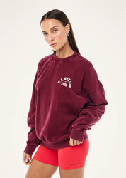 Model wearing P.E Nation Swerve 2.0 Sweat in Washed Cabernet oversized fit casual styling