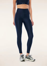 Model wearing P.E Nation Fairmont leggings dark navy shine high rise fit