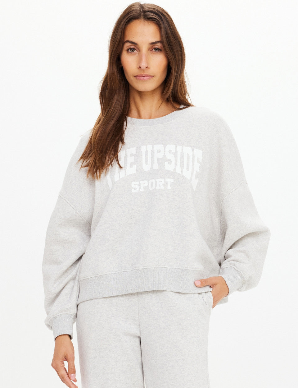 Model wearing The Upside Paloma Crew Grey Marle relaxed sweatshirt