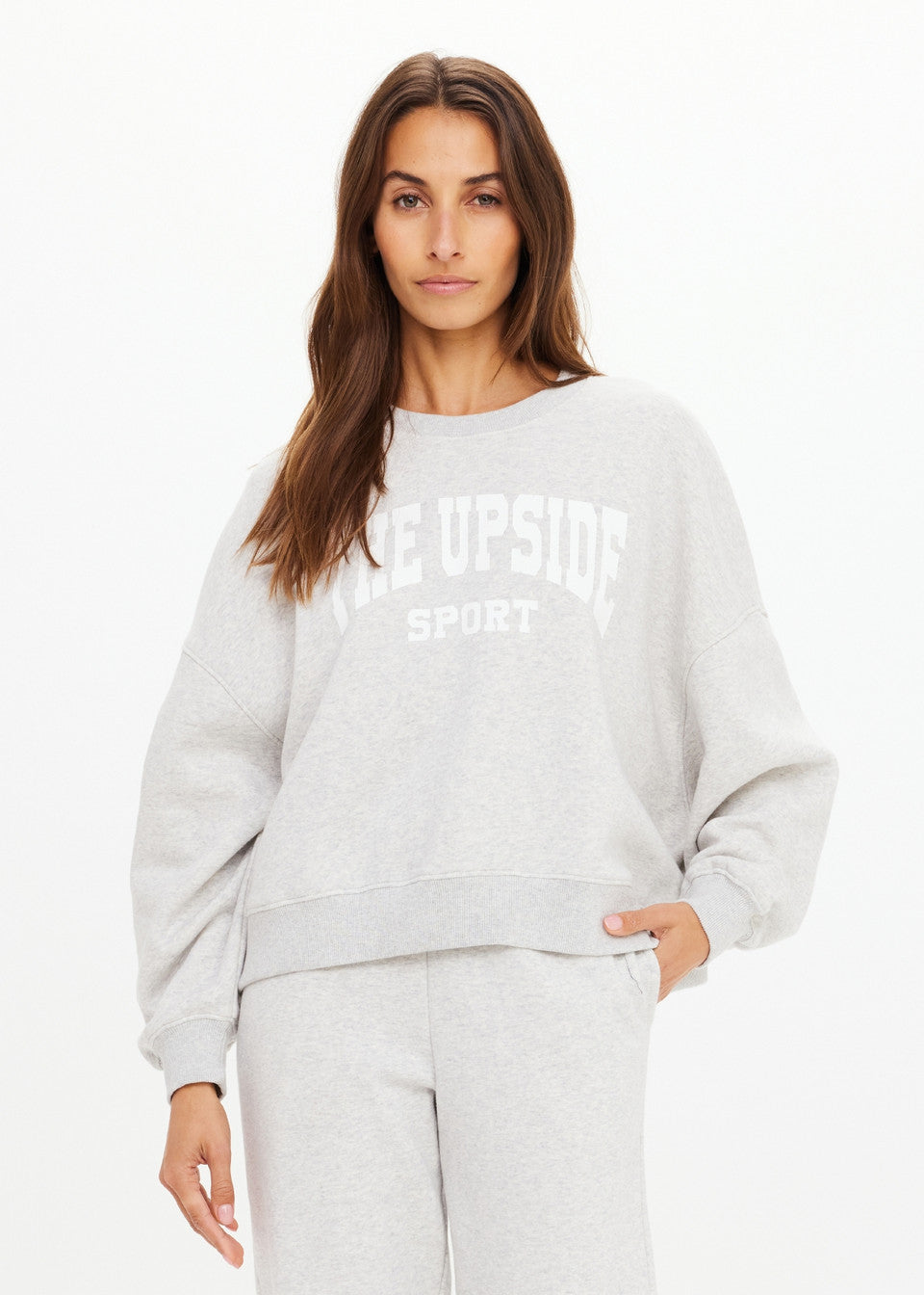 Model wearing The Upside Paloma Crew Grey Marle relaxed sweatshirt