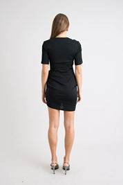 Woman wearing a black dress on a white background