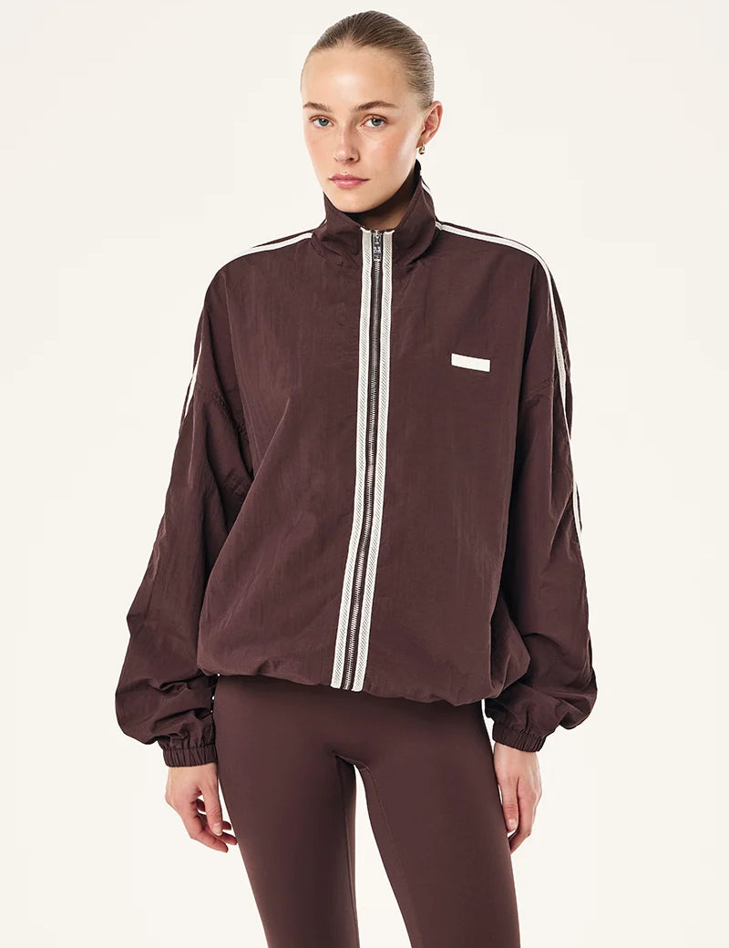 MODEL WEARING P.E Nation Radius Jacket in Dark Plum - oversized funnel neck jacket with side stripe detail