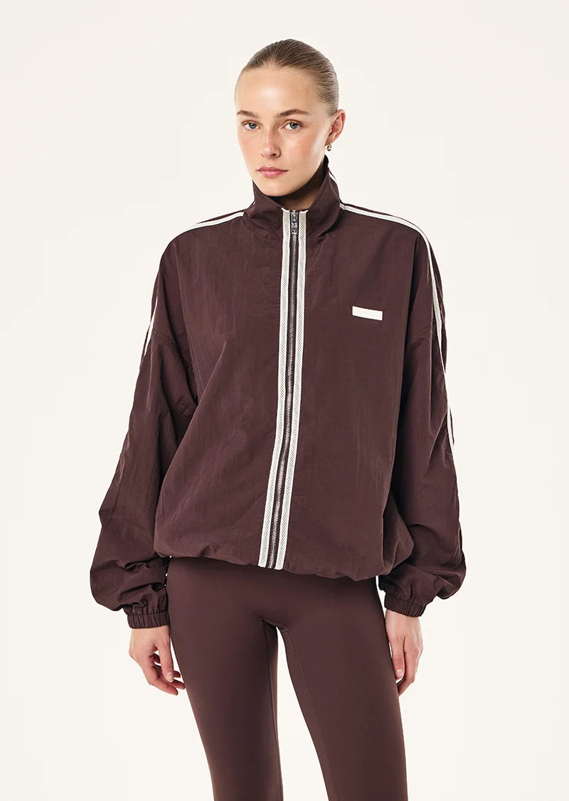 MODEL WEARING P.E Nation Radius Jacket in Dark Plum - oversized funnel neck jacket with side stripe detail