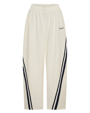 ŚSAINT Barrel Trackpant in butter with navy double side stripe detail