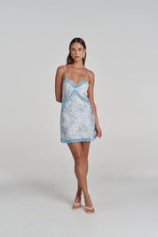 Model wearing the Summi Summi Siren Lace Mini Dress in Orchid Prism with kitten heel
