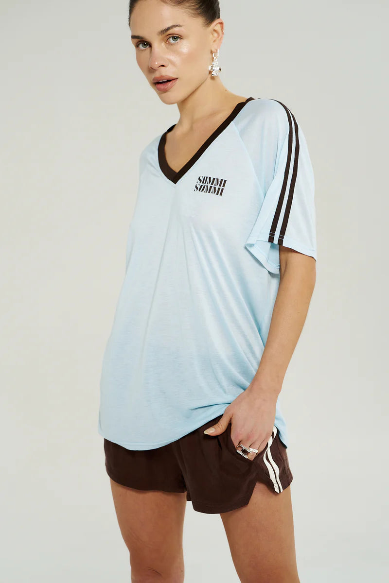 “Side view of Summi Summi V-Neck Jersey Tee in Icel Blue showing V-neckline and subtle shoulder stripe detail.”