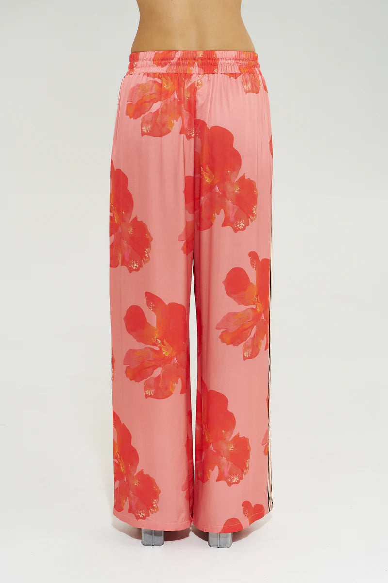 Model wearing Summi Summi La Vie Wide Leg Pant in Peach Petals print with wide leg silhouette