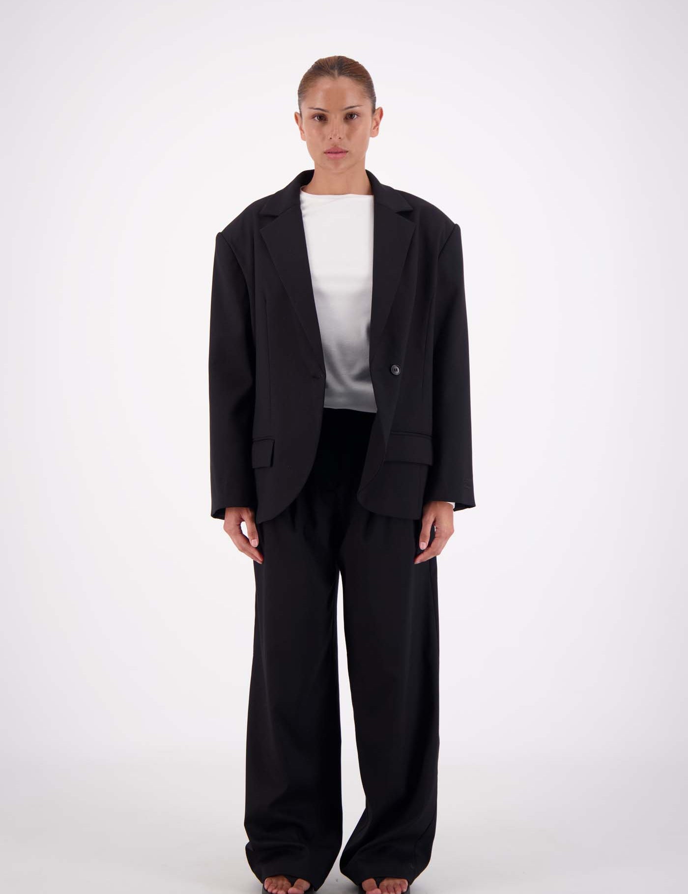 Model wearing Jasmine Alexa Sabine Blazer in Black, single button, oversized longline fit, front vie