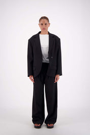 Model wearing Jasmine Alexa Sabine Blazer in Black, single button, oversized longline fit, front vie