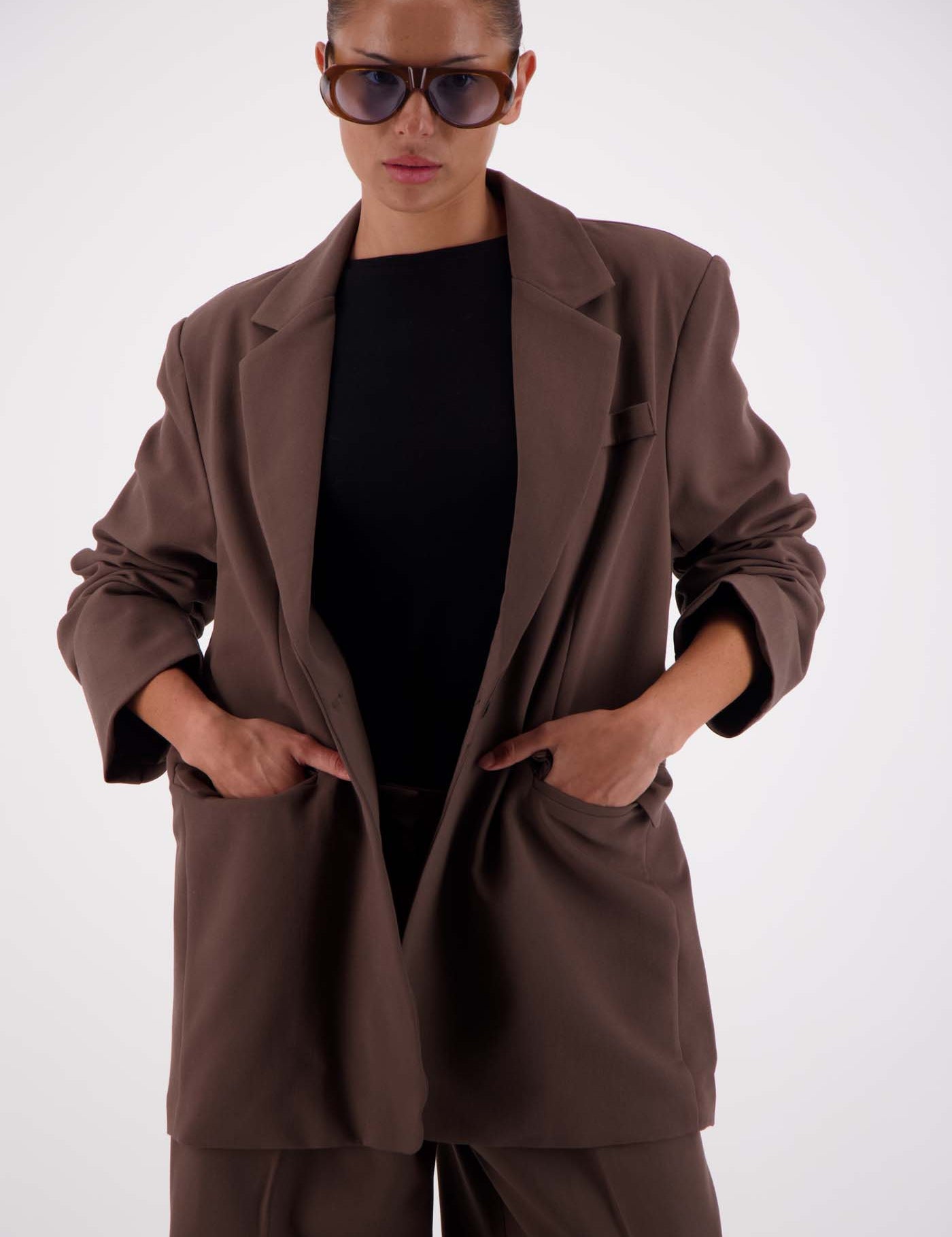 Jasmine Alexa Sabine Blazer Taupe worn open, model hands in pockets, styled with matching taupe trousers