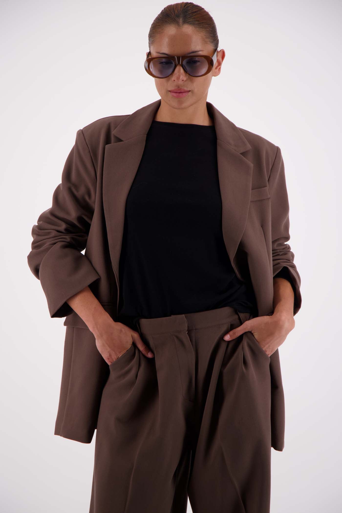 Jasmine Alexa Sabine Blazer Taupe worn open, model hands in pockets, styled with matching taupe trousers