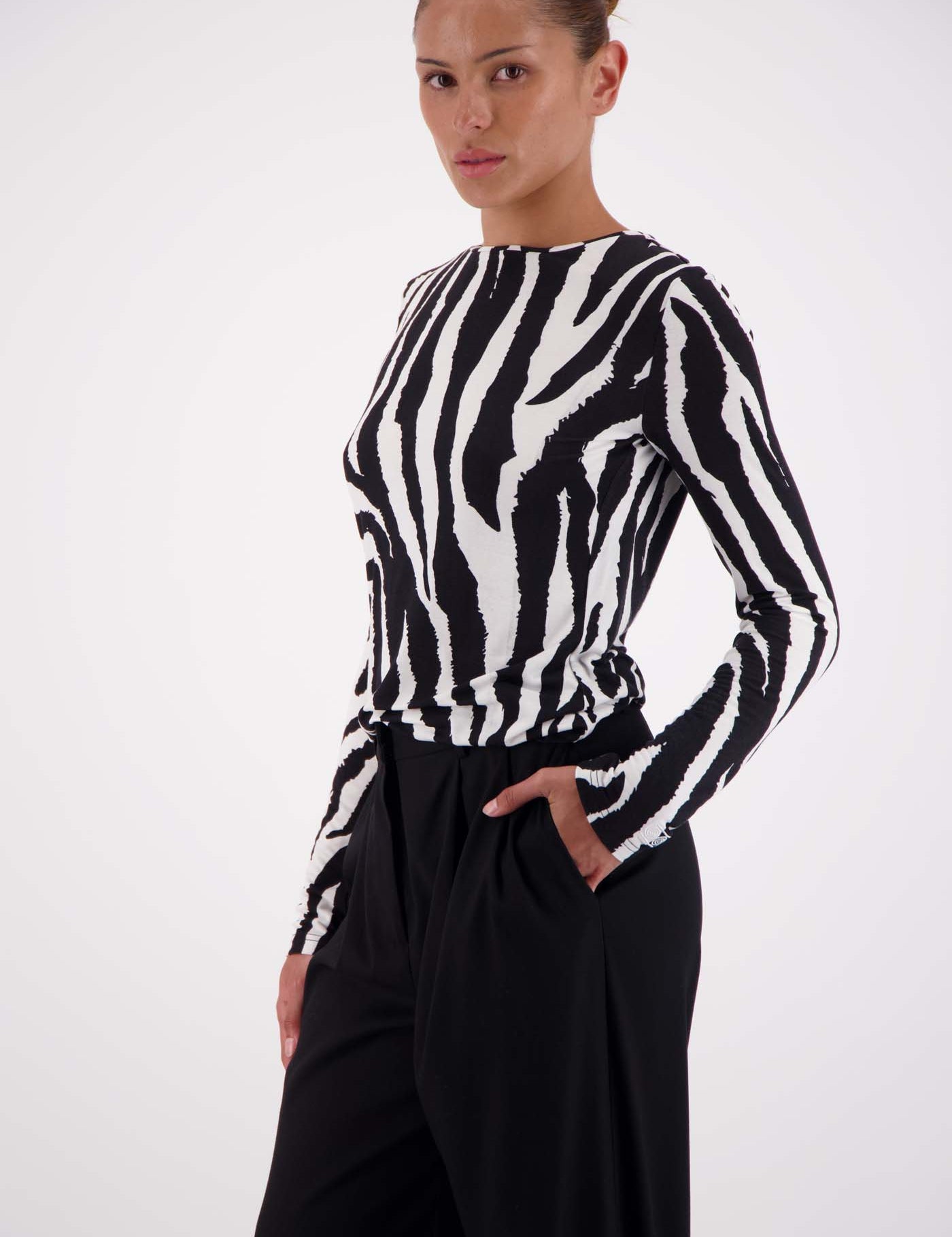 Model wearing Jasmine Alexa Soho Zebra Top with tailored trousers, size small