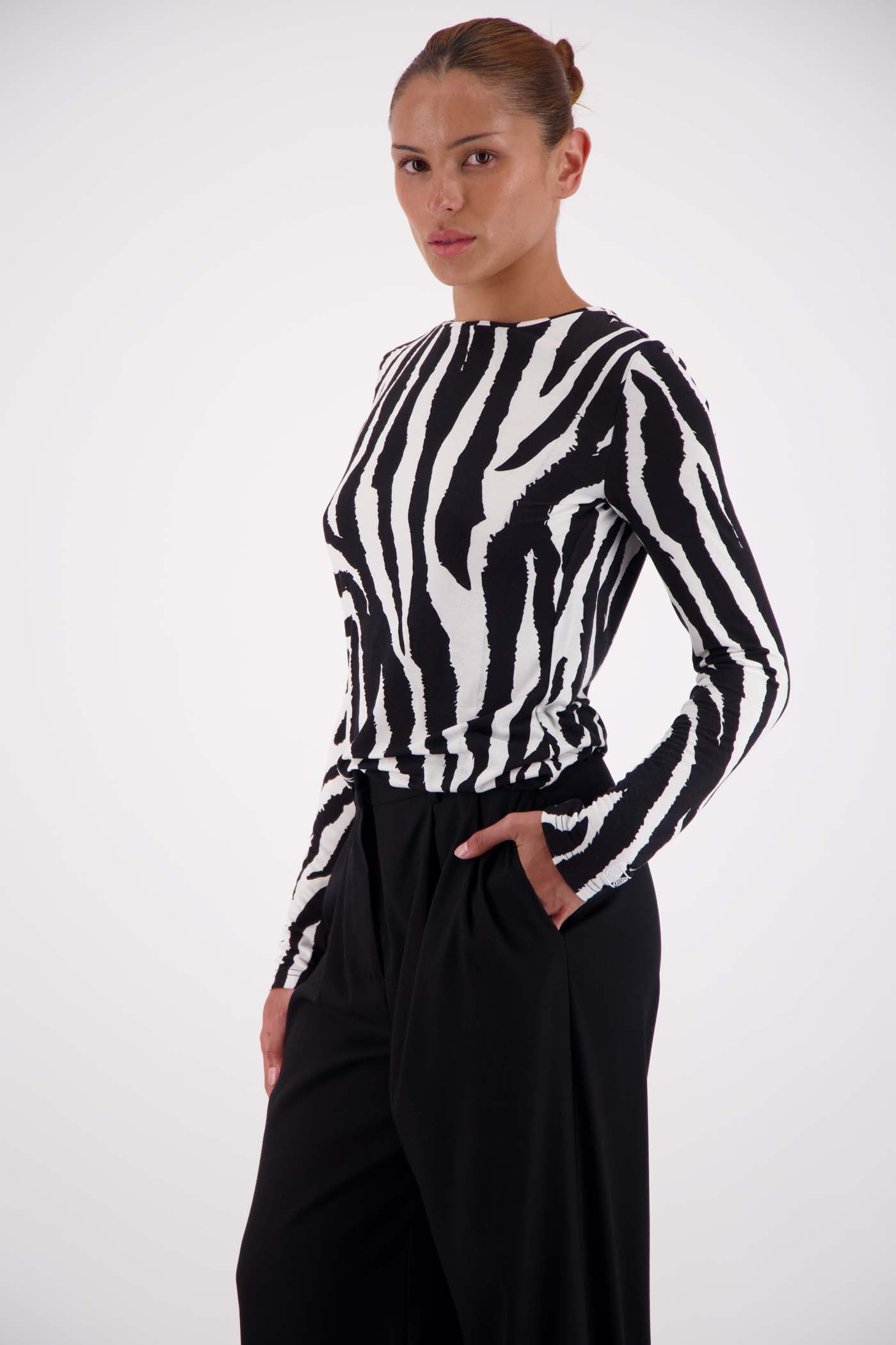 Model wearing Jasmine Alexa Soho Zebra Top with tailored trousers, size small