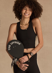 Model wearing The Upside Arcadia matching set performing Pilates, showcasing high-rise pants and longline crop top.”