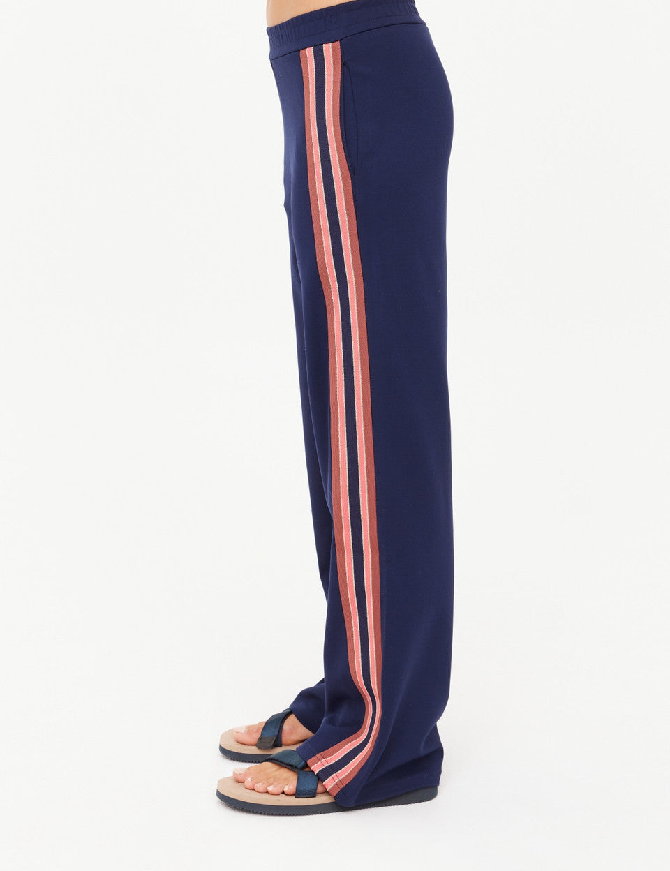 Navy blue pants with pink stripes on a white background
