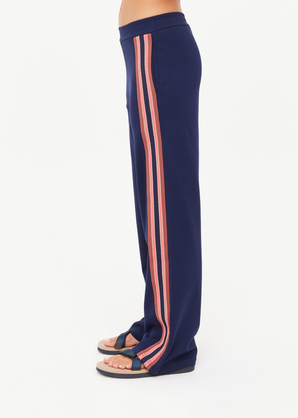 Navy blue pants with pink stripes on a white background