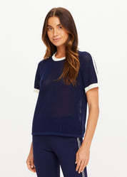 The Upside Fenway Jordan Knit Tee in navy with cream stripe sleeve detail on model with matching flare pants