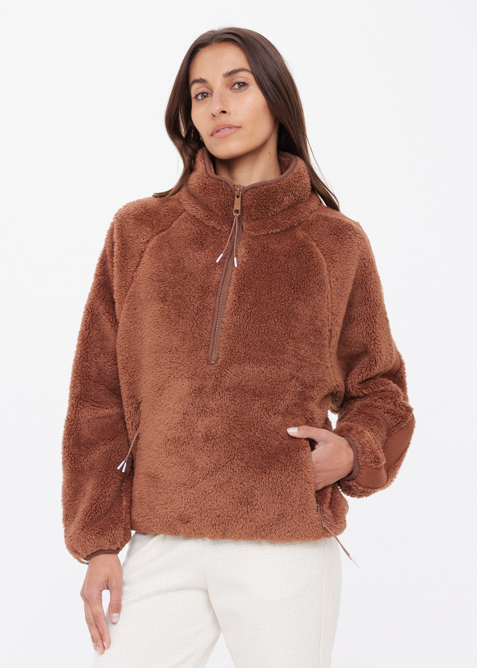 Elastic cuff and waistband detail on The Upside Harlow Fleece Pullover — warmth-locking finish in Walnut
