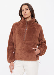 Elastic cuff and waistband detail on The Upside Harlow Fleece Pullover — warmth-locking finish in Walnut
