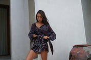Model wearing Luna lane after tide set lou wrap skirt and the romy shirt 