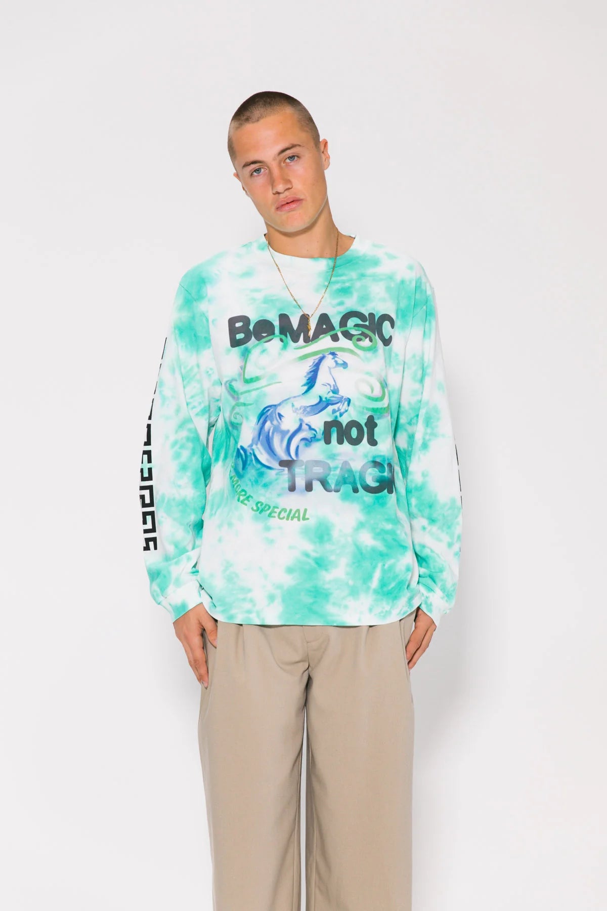 Person wearing a tie-dye shirt with text on a white background