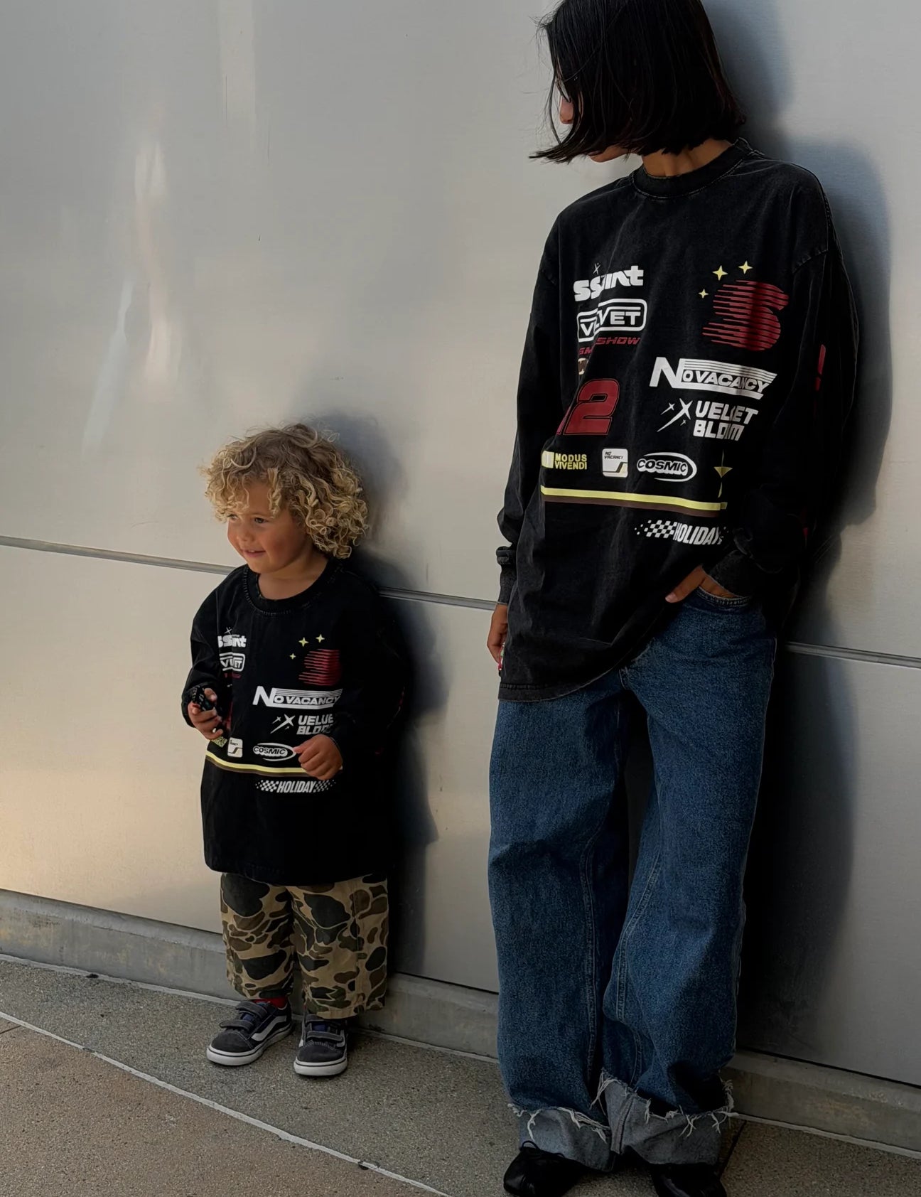 Mum and son wearing matching SSAINT Signature Moto Tee in Black Acid Wash