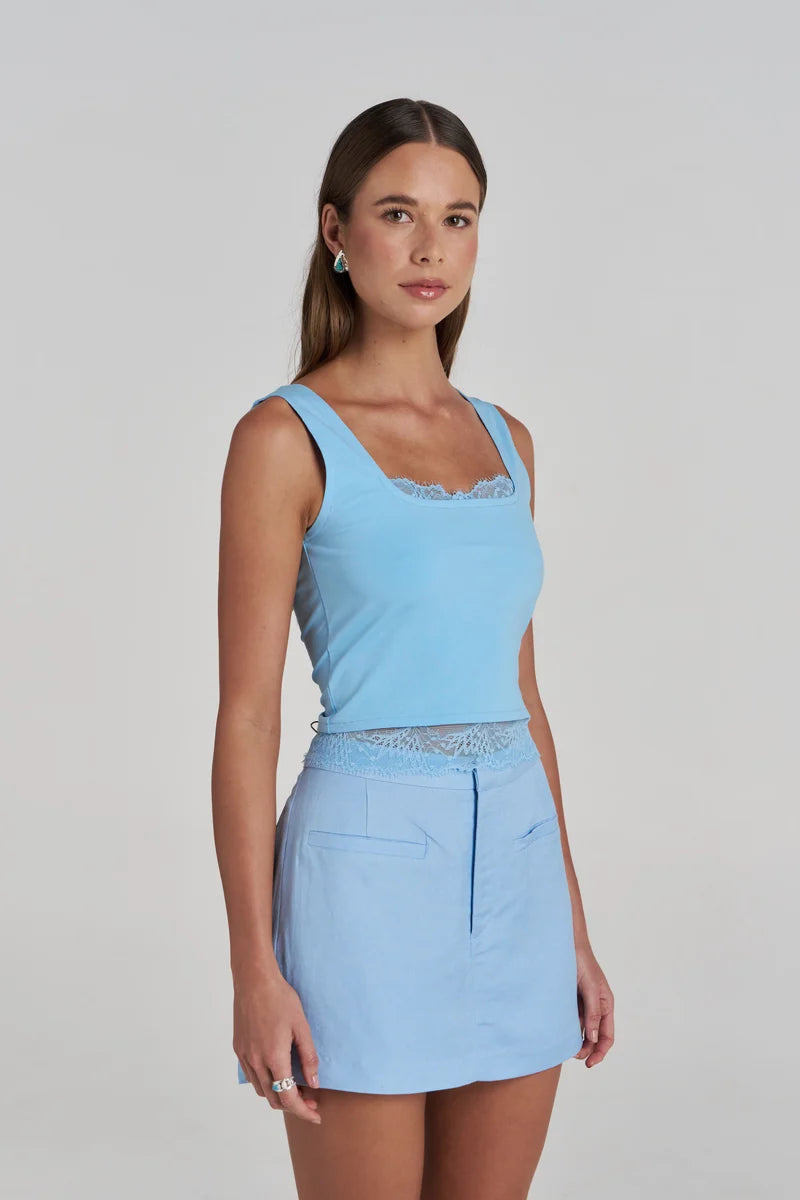 side view Model wearing the Summi Summi Ellidy Tank Top in Ocean with skort