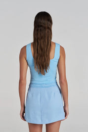 Model wearing the Summi Summi Ellidy Tank Top in Ocean with summi summi skort in ocean back view
