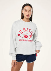 Model wearing P.E Nation Backspin Sweat grey marle oversized casual outfit