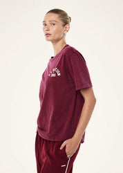 Side view of P.E Nation Swerve Tee showing relaxed fit and length