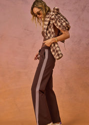side view The Upside Petra flare pant in chocolate with pink stripe detail – Wild West Sisters