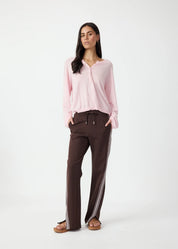 pink shirt model wearing The Upside Petra flare pant in chocolate with pink stripe detail – Wild West Sisters